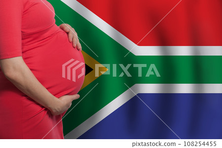 Close up photo of pregnant woman belly on flag of South African Republic background Close up photo of pregnant woman belly on flag of South African Republic background 108254455
