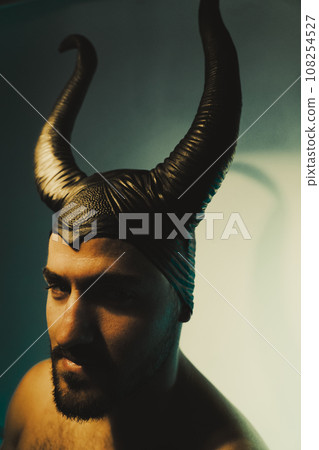 Man with horns on head studio shot Man with horns on head studio shot 108254527