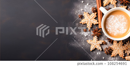 A mug of hot cocoa or chocolate drink and Christmas homemade cookies decorated with sugar sweet icing A mug of hot cocoa or chocolate drink and Christmas homemade cookies decorated with sugar sweet icing 108254691