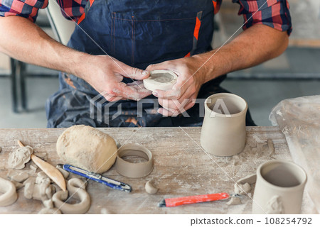 Talanted caucasian man making decoration for cap. Talanted caucasian man making decoration for cap. 108254792