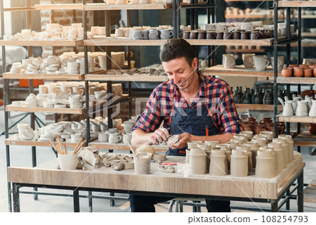 Talanted caucasian man making decoration for cup. 108254793