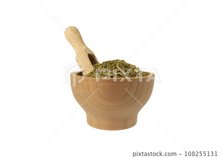 passion flower herb in latin - passiflora incarnata in wooden bowl and scoop isolated on white background. Medicinal herb. passion flower herb in latin - passiflora incarnata in wooden bowl and scoop isolated on white background. Medicinal herb. 108255131