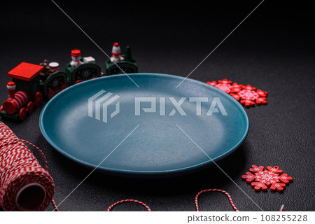 Ceramic round plate decorated with festive elements on the Christmas table Ceramic round plate decorated with festive elements on the Christmas table 108255228