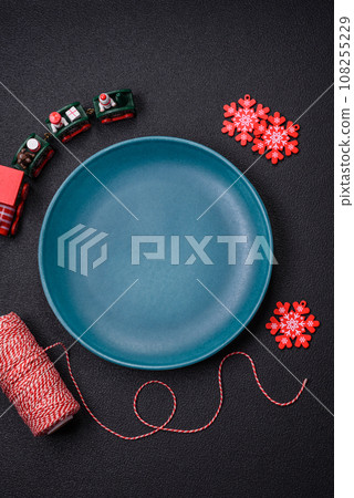 Ceramic round plate decorated with festive elements on the Christmas table Ceramic round plate decorated with festive elements on the Christmas table 108255229