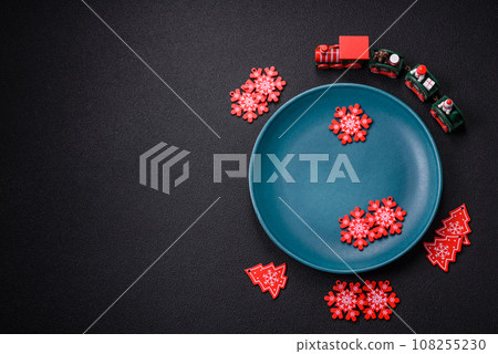 Ceramic round plate decorated with festive elements on the Christmas table Ceramic round plate decorated with festive elements on the Christmas table 108255230