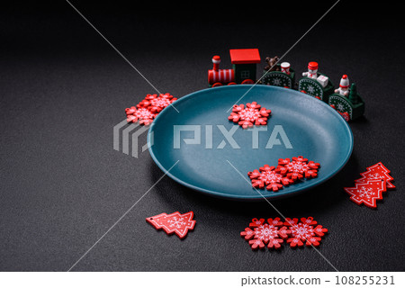 Ceramic round plate decorated with festive elements on the Christmas table Ceramic round plate decorated with festive elements on the Christmas table 108255231
