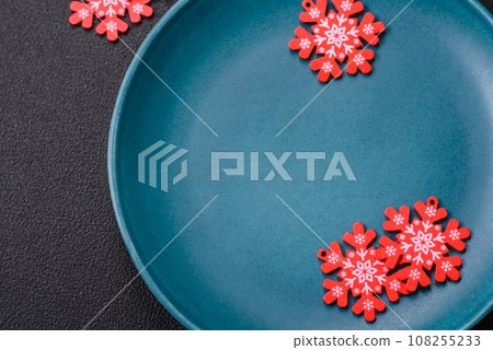 Ceramic round plate decorated with festive elements on the Christmas table Ceramic round plate decorated with festive elements on the Christmas table 108255233