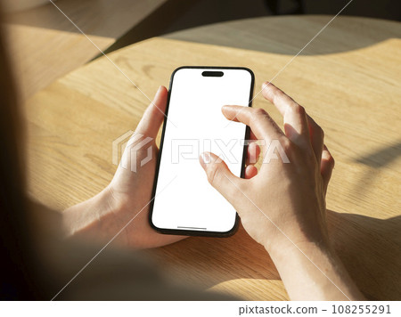 Berlin, Germany October 20 2023 Finger zooming, enlarging picture on phone screen mockup 108255291