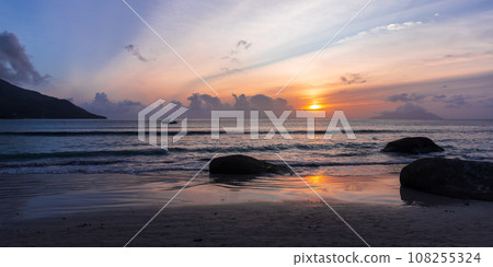 Coastal rocks on the beach at sunset. Mahe island, Seychelles Coastal rocks on the beach at sunset. Mahe island, Seychelles 108255324