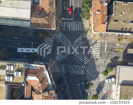 Top view over a crowd pedestrian crossing road intersection, Belgrade. Aerial view od traffic at busy scramble crosswalk Top view over a crowd pedestrian crossing road intersection, Belgrade. Aerial view od traffic at busy scramble crosswalk 108255425