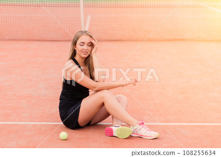 Tennis tournament. Female player at the clay tennis court Tennis tournament. Female player at the clay tennis court 108255634