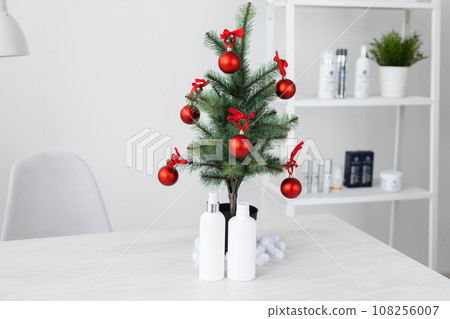 Winter skin care cosmetic products under Christmas tree. Face cream and hand creme or body lotion tube mockup. Holiday gift and seasonal skin protection Winter skin care cosmetic products under Christmas tree. Face cream and hand creme or body lotion tube mockup. Holiday gift and seasonal skin protection 108256007