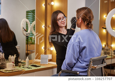Microblading Artist, Beauty Treatment, Brow Treatment. Beauty salon offers eyebrow correction services, where adult woman is currently experiencing microblading for her brows. 108257707