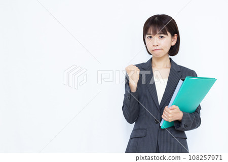 Angry working woman in her 30s in front of a white background 108257971