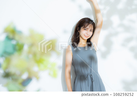 A woman stretching, sunlight filtering through the trees A woman stretching, sunlight filtering through the trees 108259252