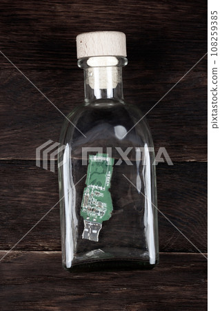 USB memory stick as letter in bottle 108259385