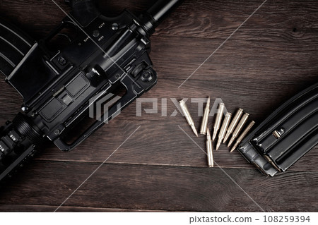 Rifle and Ammunition with magazine on wooden table Rifle and Ammunition with magazine on wooden table 108259394