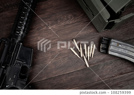 Rifle and Ammunition with magazine on wooden table 108259399