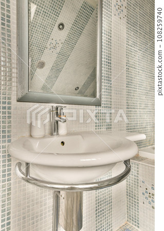 a white sink and mirror in a room with blue tiles on the wall behind it is an open shower stall a white sink and mirror in a room with blue tiles on the wall behind it is an open shower stall 108259740