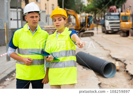 Civil engineers checking work process in construction site 108259897