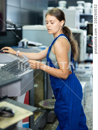Warehouse girl employee look at computer monitor screen and check completeness of order for customer Warehouse girl employee look at computer monitor screen and check completeness of order for customer 108260032