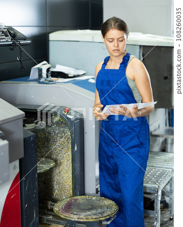 Girl of warehouse store construction and repair materials mix different shades and colors in device 108260035