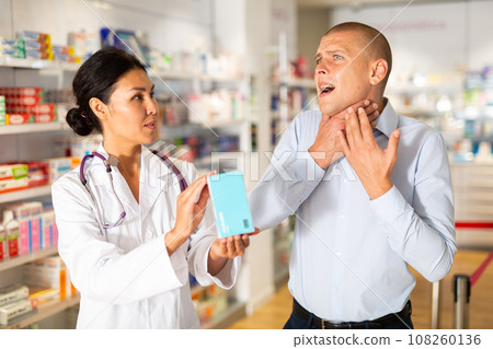 Man complaining to female druggist about sore throat 108260136