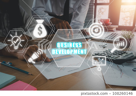 Business development concept, Business team analyzing income charts and graphs on office desk wiht business development icon on virtual screen. 108260146