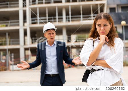 Depressed woman having problems at construction site 108260162