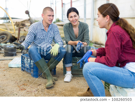 Three workers talking 108260503