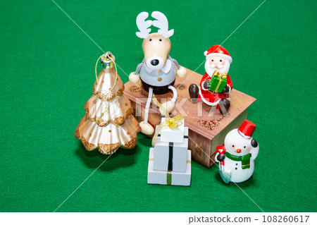 Table photo with miniature Santa, reindeer, presents and books Table photo with miniature Santa, reindeer, presents and books 108260617