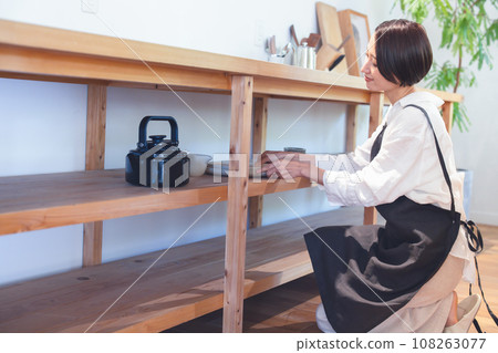 A woman doing housework in the kitchen A woman doing housework in the kitchen 108263077