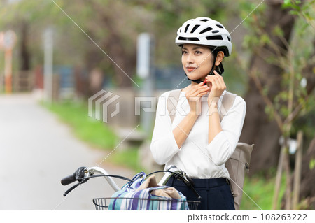 young woman wearing a cycling helmet young woman wearing a cycling helmet 108263222