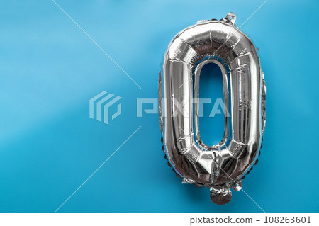 0 zero metallic balloon isolated on blue background. Greeting card silver foil balloon number Happy birthday holiday concept. Copy space for text. Celebration party congratulation 108263601