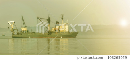 Fishing trawler in the Bay on the roads in Vladivostok on soft sunlight Fishing trawler in the Bay on the roads in Vladivostok on soft sunlight 108265959