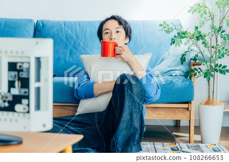 young man watching tv at home 108266653