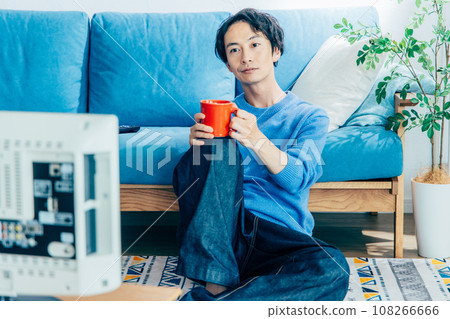 young man watching tv at home 108266666