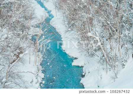Shirahige Waterfall with Snow in winter, Biei river flow into Blue Pond. landmark and popular for attractions in Hokkaido, Japan. Travel and Vacation concept Shirahige Waterfall with Snow in winter, Biei river flow into Blue Pond. landmark and popular for attractions in Hokkaido, Japan. Travel and Vacation concept 108267432
