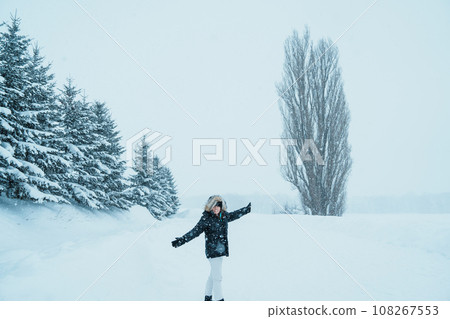 Woman tourist Visiting in Biei, Traveler in Sweater sightseeing Tree of Ken and Marry with Snow in winter season. landmark and popular for attractions in Hokkaido, Japan. Travel and Vacation concept 108267553