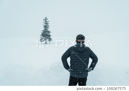 man tourist Visiting in Biei, Traveler in Sweater sightseeing Christmas tree with Snow in winter season. landmark and popular for attractions in Hokkaido, Japan. Travel and Vacation concept 108267575