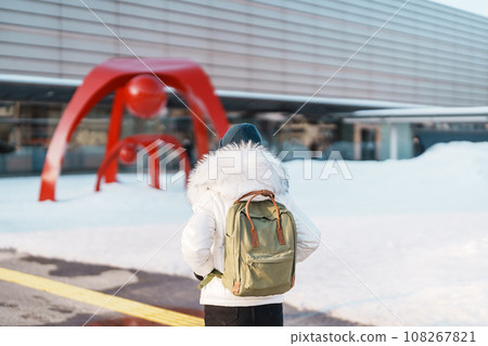 Woman tourist Visiting in Hakodate, Traveler in Sweater sightseeing Hakodate Train Station with Snow in winter. landmark and popular for attractions in Hokkaido,Japan.Travel and Vacation concept Woman tourist Visiting in Hakodate, Traveler in Sweater sightseeing Hakodate Train Station with Snow in winter. landmark and popular for attractions in Hokkaido,Japan.Travel and Vacation concept 108267821