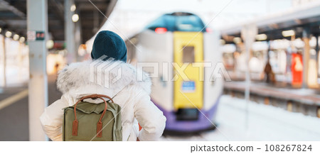Woman tourist with bag in Train Station platform with Snow in winter. Hakodate, Hokkaido, Japan.Travel and Vacation concept 108267824