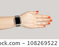 Closeup of woman hand with smartwatch with empty display handshaking with partner. Indoor studio shot isolated on gray background. 108269522