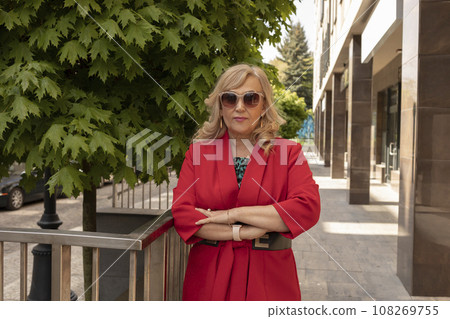 Portrait Posing Business Lady, Mature Sexagenarian Woman Outdoor in Summer Time, City, Stylish Confident Senior Female in her 60s Wears Sunglasses. Boss or Manager. Horizontal Plane. 108269755