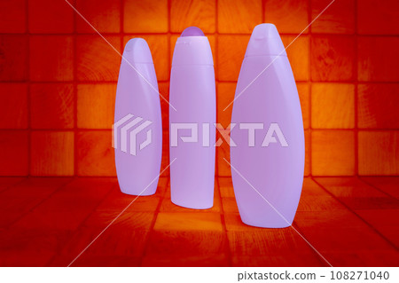 Plastic blue glowing bottles for detergents red wood background squares 108271040