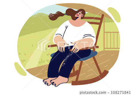 Relaxed woman sits on rocking chair in park or garden enjoying rays of summer sun 108271841