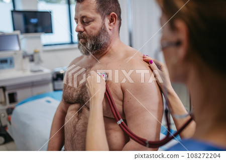 Overweight patient having problem with breathing, doctor using stethoscope detecting asthma. Obesity affecting middle-aged men's health. Concept of health risks of overwight and obesity. 108272204