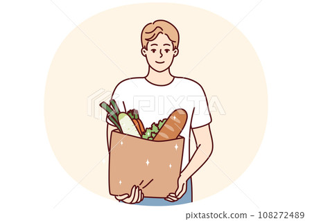 Smiling man holding bag with groceries 108272489