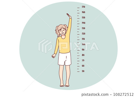 Small girl show height on measurement 108272512