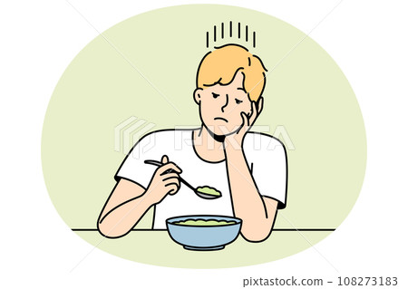 Guy without appetite looks at lean diet dish. 108273183